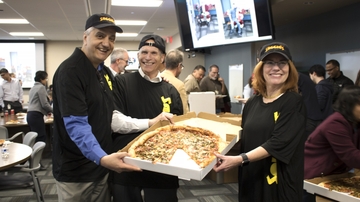 UNM leadership puts on pizza hats to surprise departments