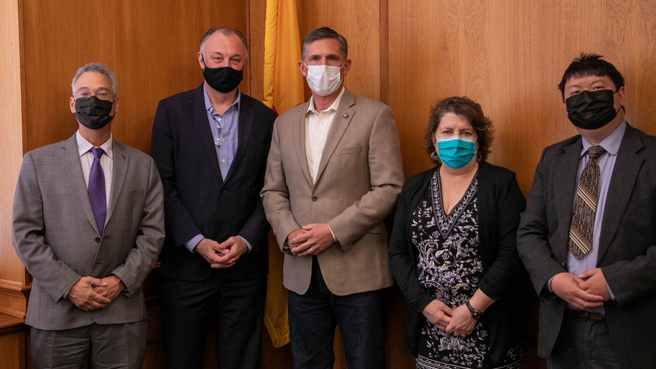 UNM researchers pose with Sen. Martin Heinrich