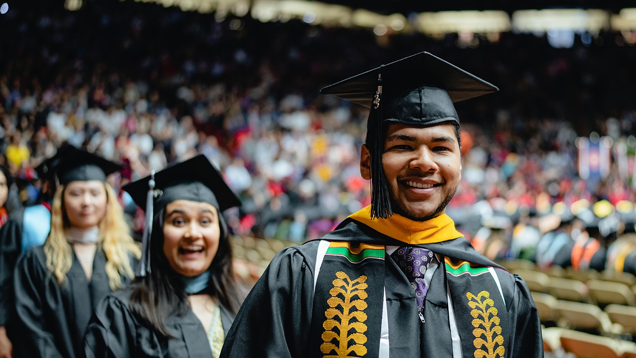 Grad smiles upon arena entry.