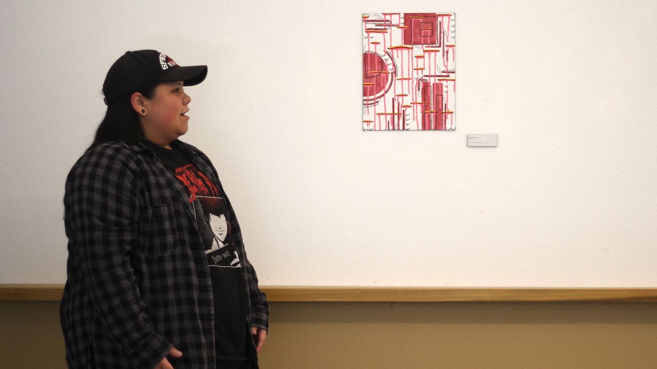 Students present artwork at Spectra Gallery.