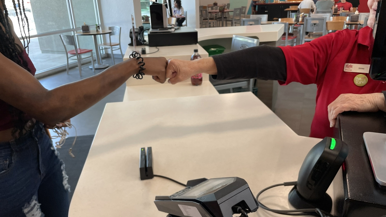 Shirley Tartaglia issues her signature Friday fist bump to a student.