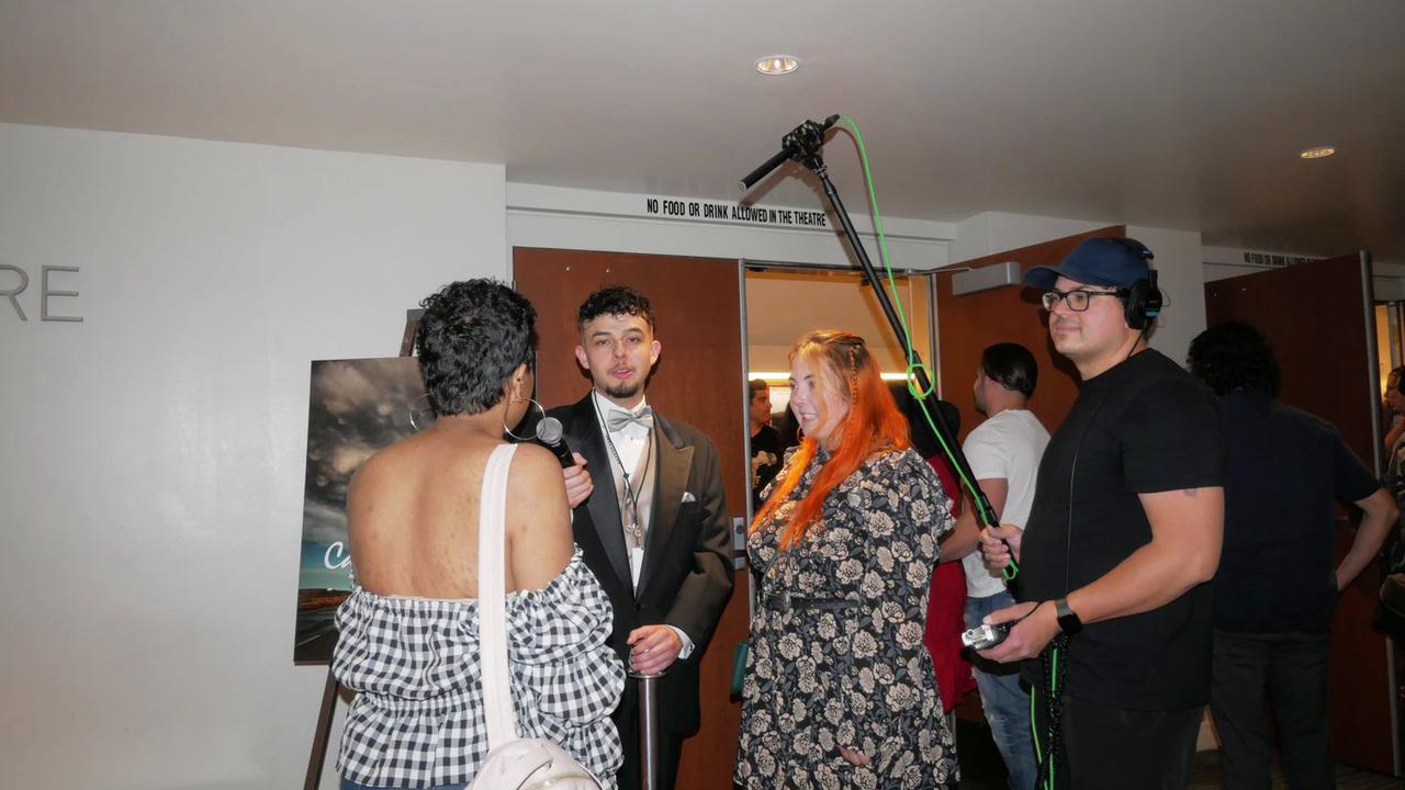 Students stop for interviews along the red carpet.