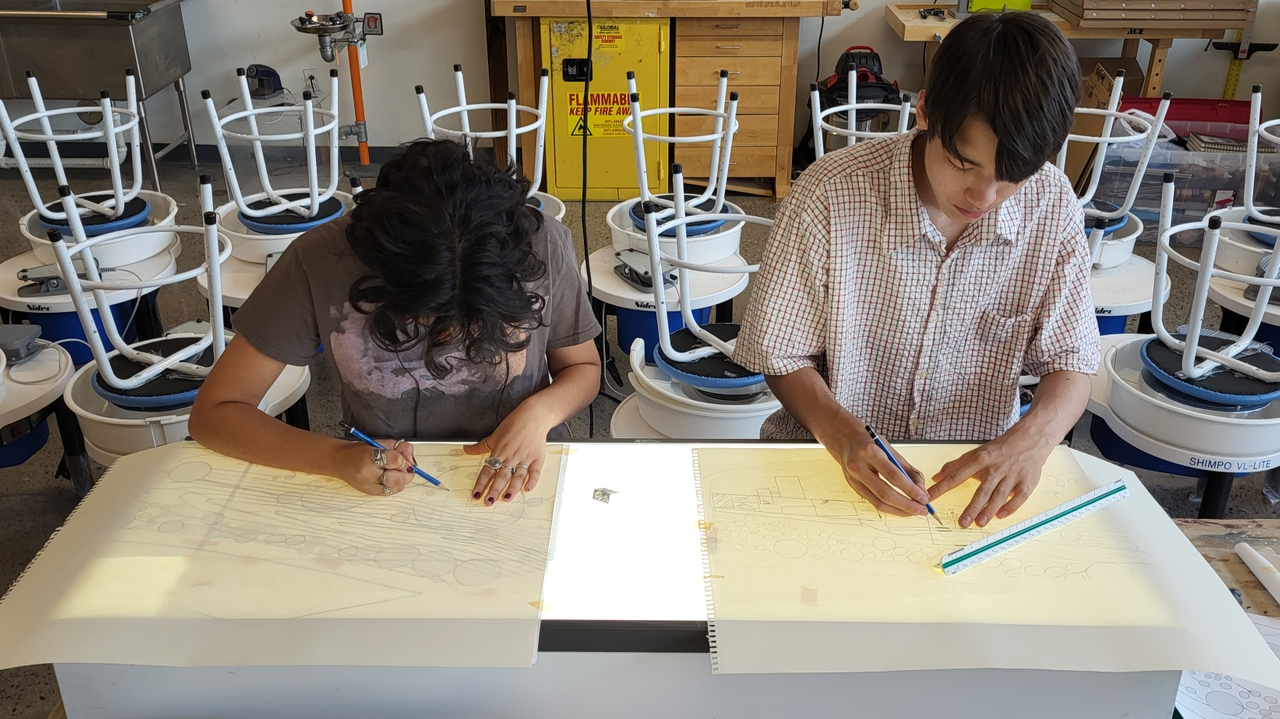 Students drawing and sketching their designs