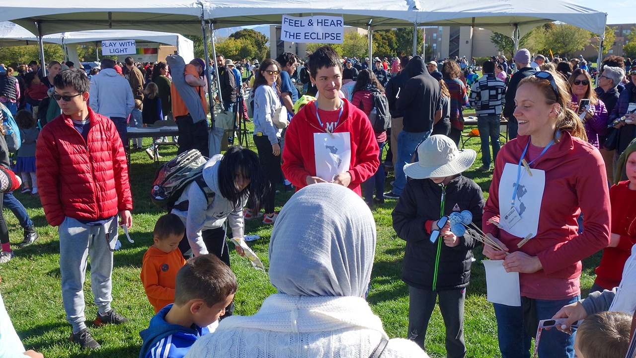A child participates in one of the exhibits as part of UNM eclipse watch party. 