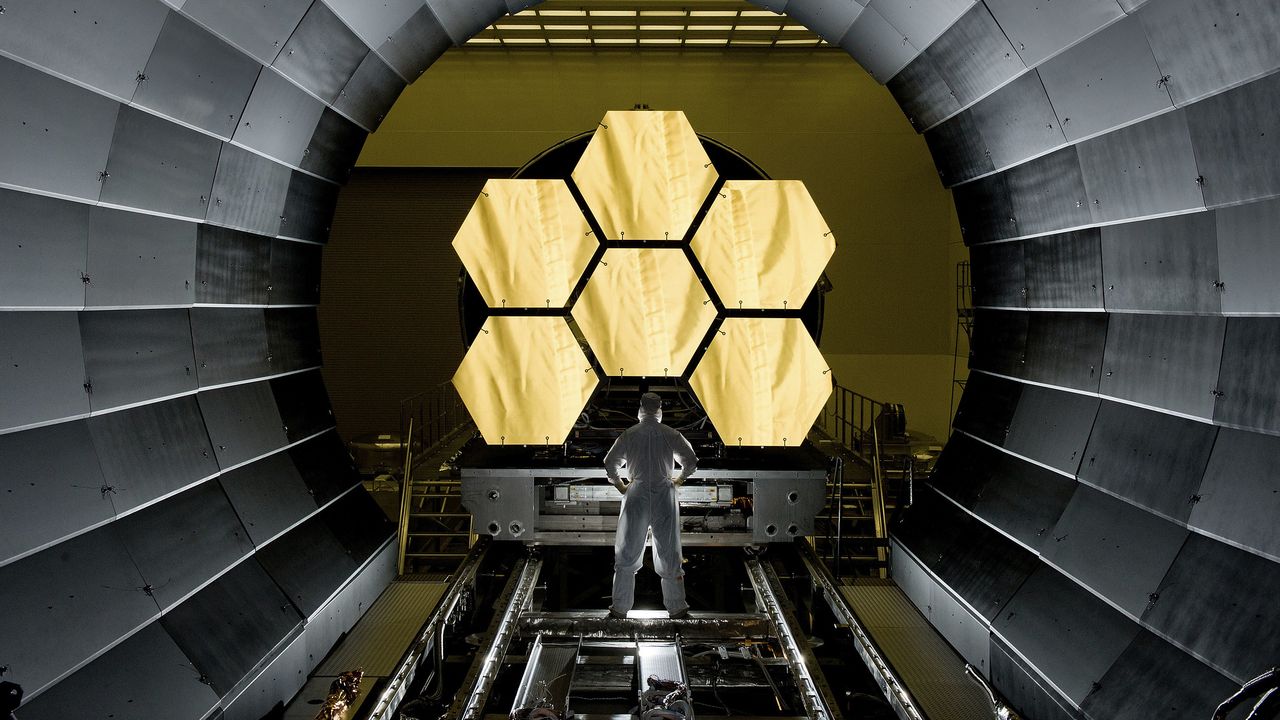 NASA engineer Ernie Wright looks on as the first six flight ready James Webb Space Telescope's primary mirror segments are prepped to begin final cryogenic testing at NASA's Marshall Space Flight Center.   