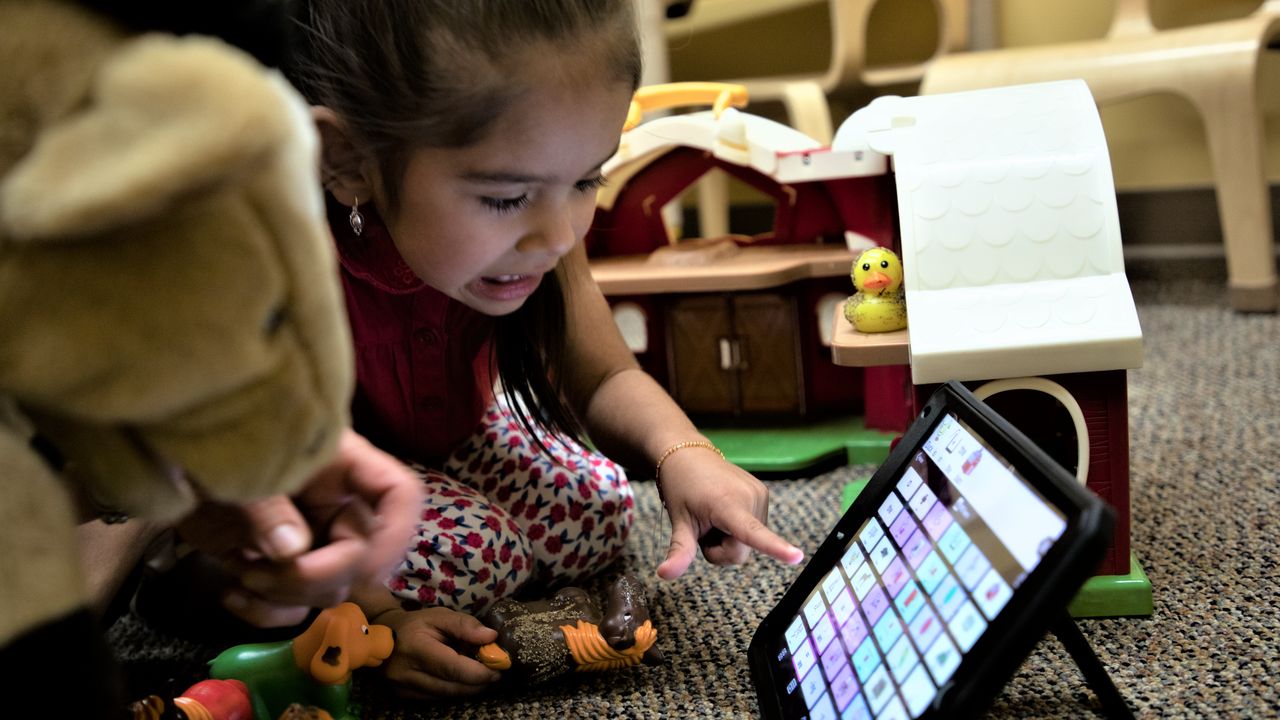 Child works with AAC to form words and sentences