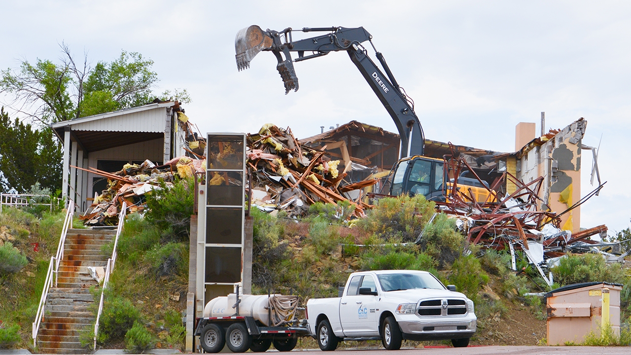 Workers for C&C Demolition Services use 