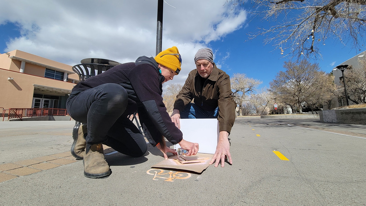 Volunteers stencil a 