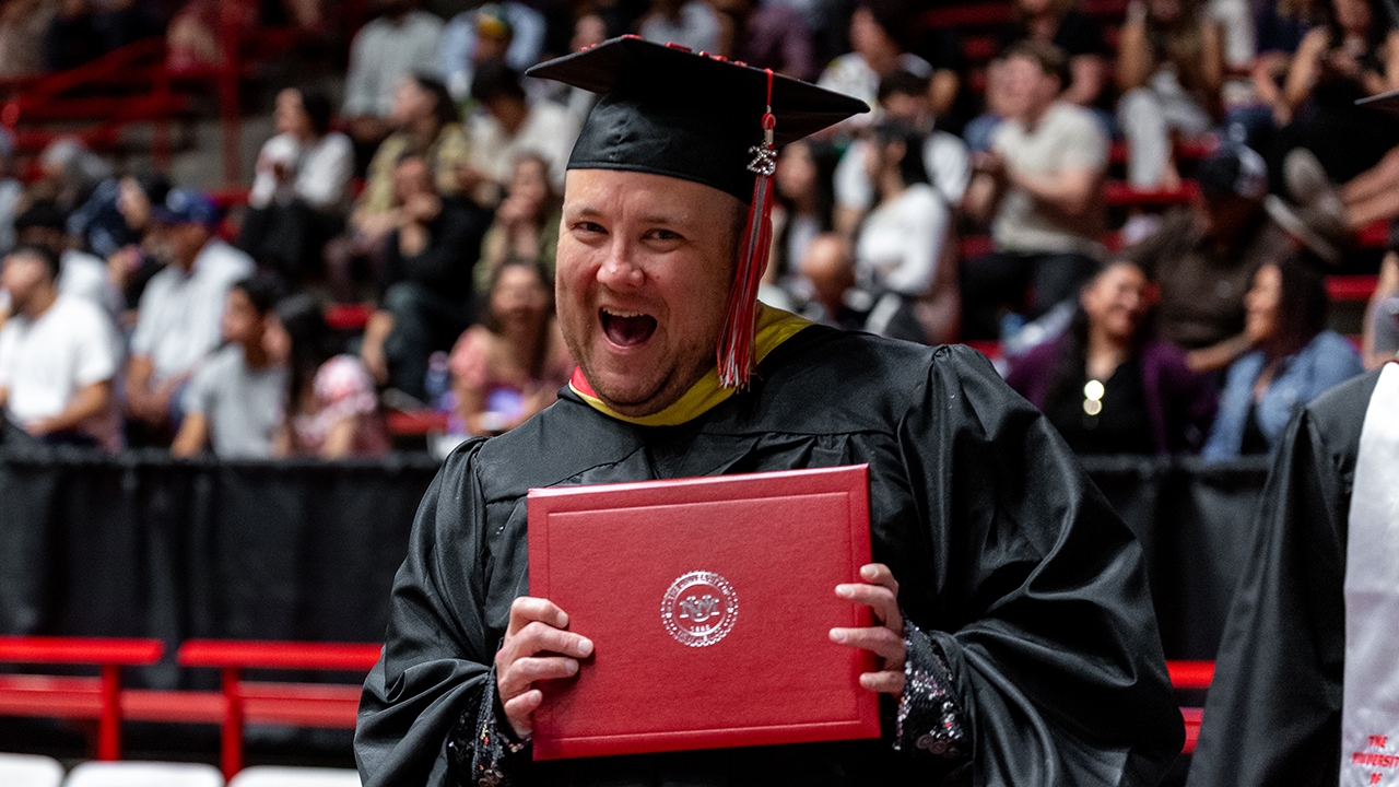 A graduate student celebrates