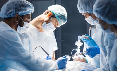 Diverse Team of surgeon, assistants and nurses making invasive surgery