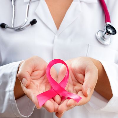 Doctor Hands Holding Pink Cancer Awareness Ribbon