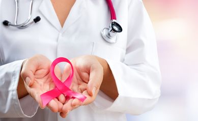 Doctor Hands Holding Pink Cancer Awareness Ribbon