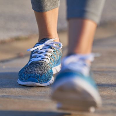 view of feet of sporty woman walking, copy space, unfocused view