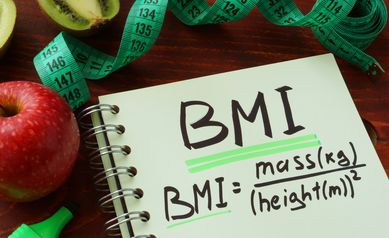 BMI body mass index written on a notepad sheet.
