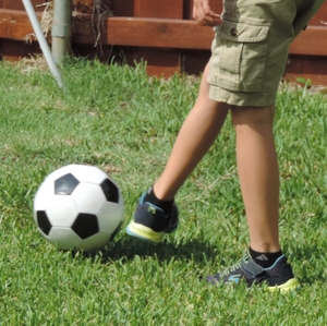 Boy kicks soccer ball