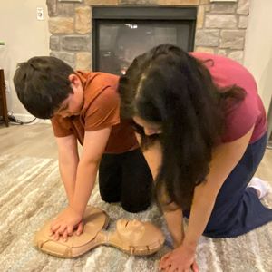 Mom showing son CPR