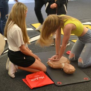 College student practicing Hands-Only CPR