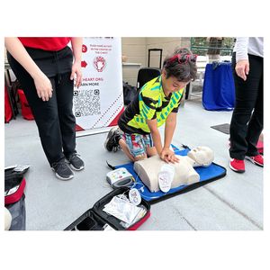 Participant practicing Hands-Only CPR and AED use